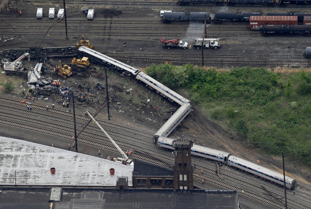 Emergency personnel work at the scene of a deadly train derailment, Wednesday, May 13, 2015, in Philadelphia. The Amtrak train, headed to New York City, derailed and crashed in Philadelphia on Tuesday night, killing at least six people and injuring dozens of others. Image by AP Photo/Patrick Semansky.