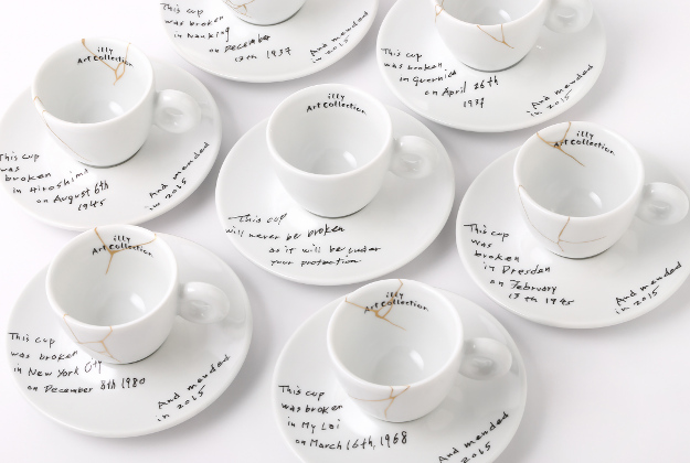 This image released by Illy North America shows a collection of espresso cups and saucers called, Yoko Ono: Mended Cups - illy Art Collection, featuring the dates and places of six tragic events written in Ono's handwriting. 