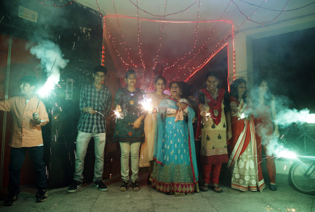 Indians play with firecrackers to celebrate Diwali in Allahabad, India on Wednesday. 