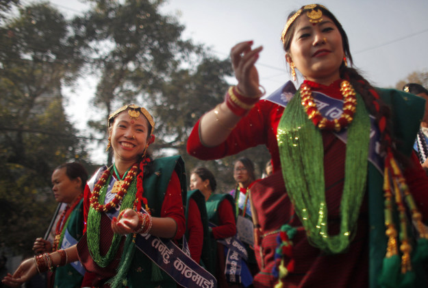 Nepalese Gurung community men and women wearing traditional attire dance at a parade to mark their New Year known as "Tamu Loshar" in Kathmandu, Nepal, Wednesday, Dec. 30, 2015. The indigenous Gurungs, also known as Tamu, are celebrating the advent of the year of the monkey. 